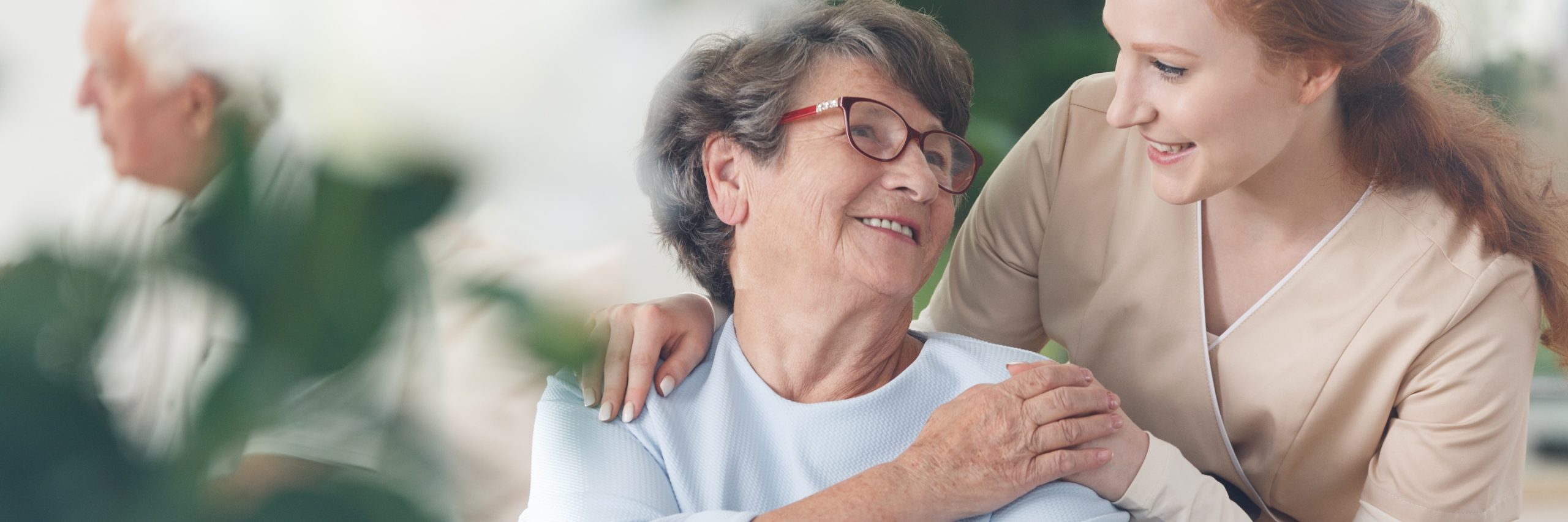 Professional,Helpful,Caregiver,Comforting,Smiling,Senior,Woman,At,Nursing,Home